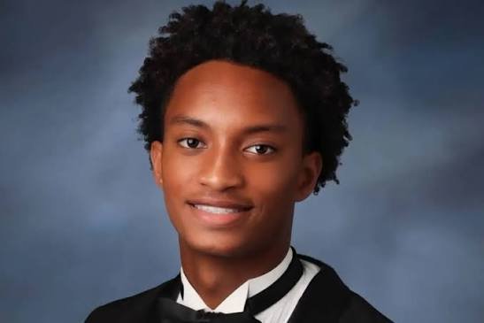 Nolan Wells in his senior portrait, smiling, wearing a tuxedo and bow tie